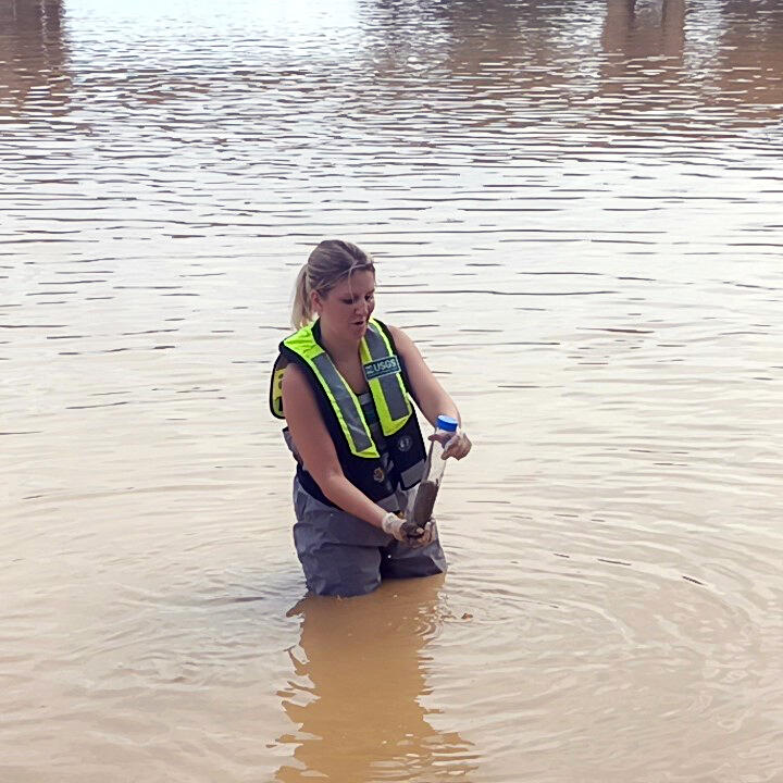 USGS chemist collecting a sediment core for mercury analysis, Ankobra River, Ghana
