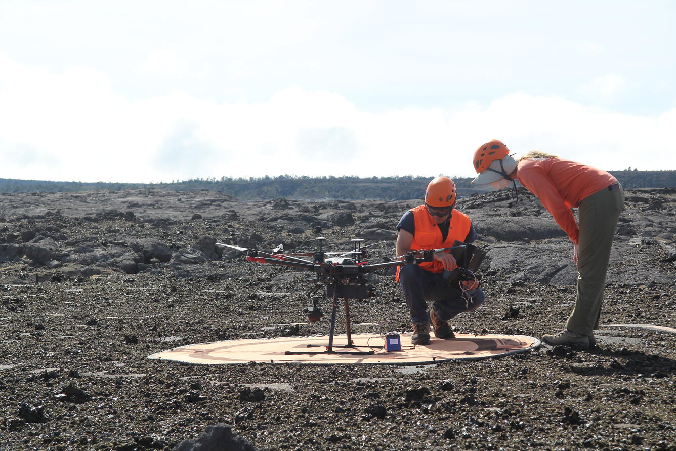 Color photograph of two scientists inspecting UAS