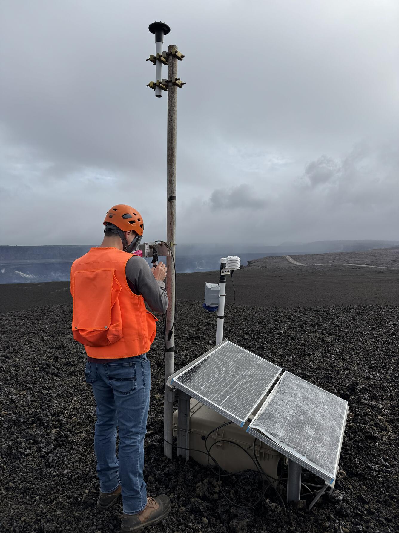 Color photograph of scientist checking monitoring equipment