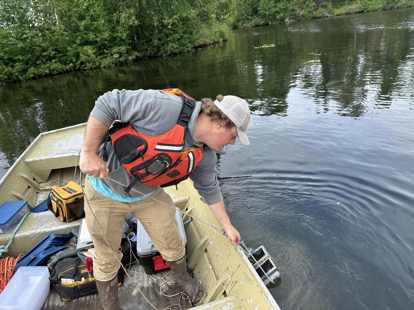 Graduate student is collecting substrate samples on Big Lake, Alaska