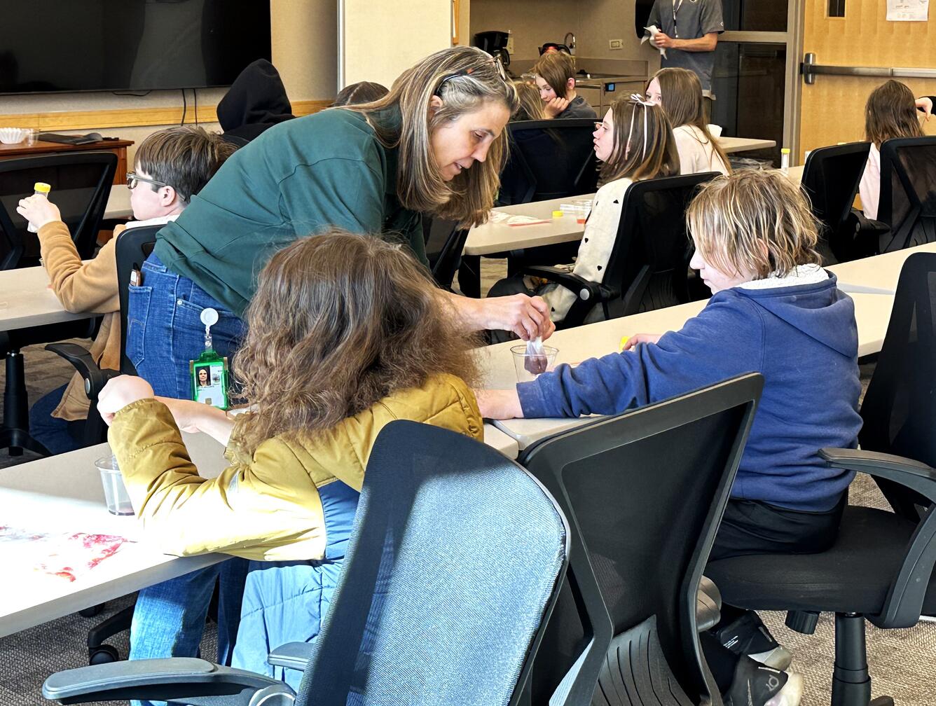 teacher demonstrating an activity to a student