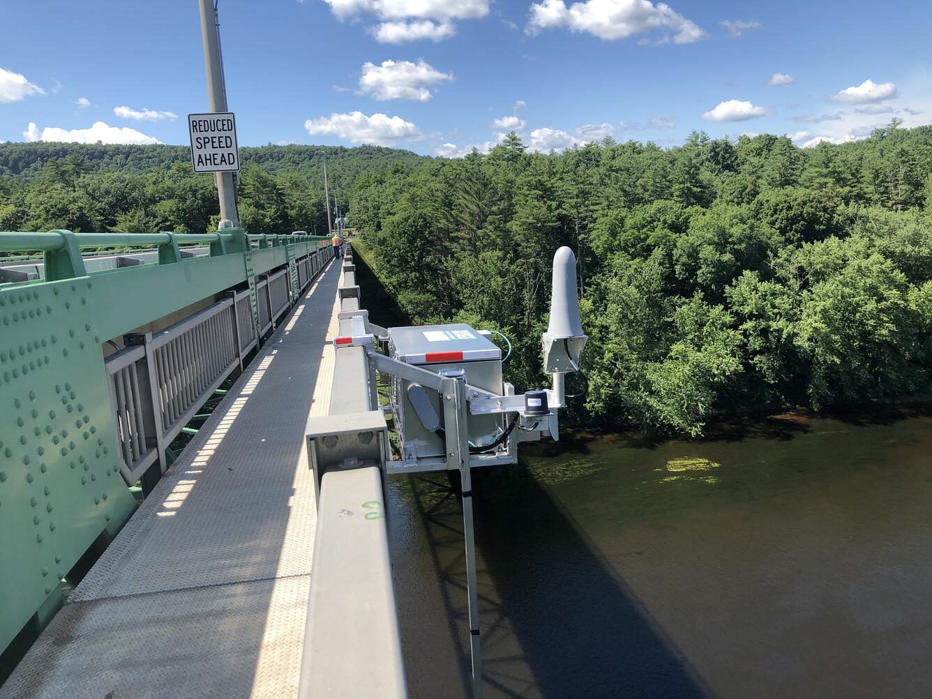 Looking across a high bridge at the radar telemetry box on the downstream side