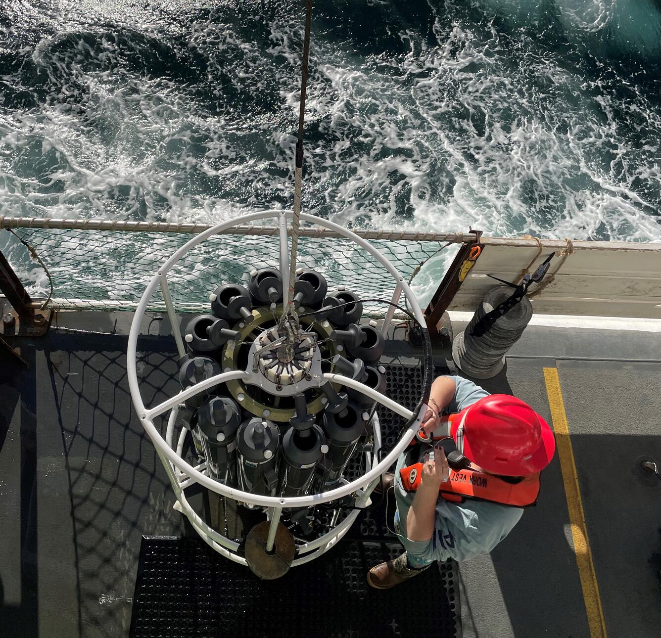 Researcher aboard NOAA's R/V Bell M. Shimada prepares to deploy a conductivity, temperature, and depth (CTD) sensor array