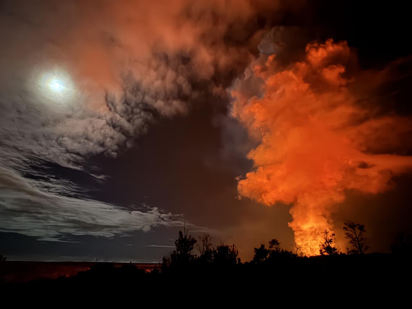 Color photograph of volcanic plume and full moon