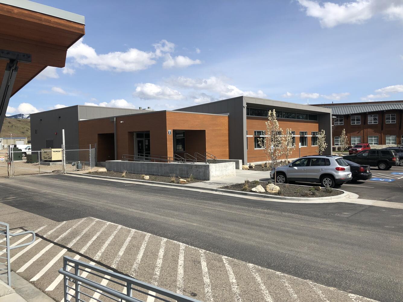 the exterior of a building with blue sky and mountains in the background