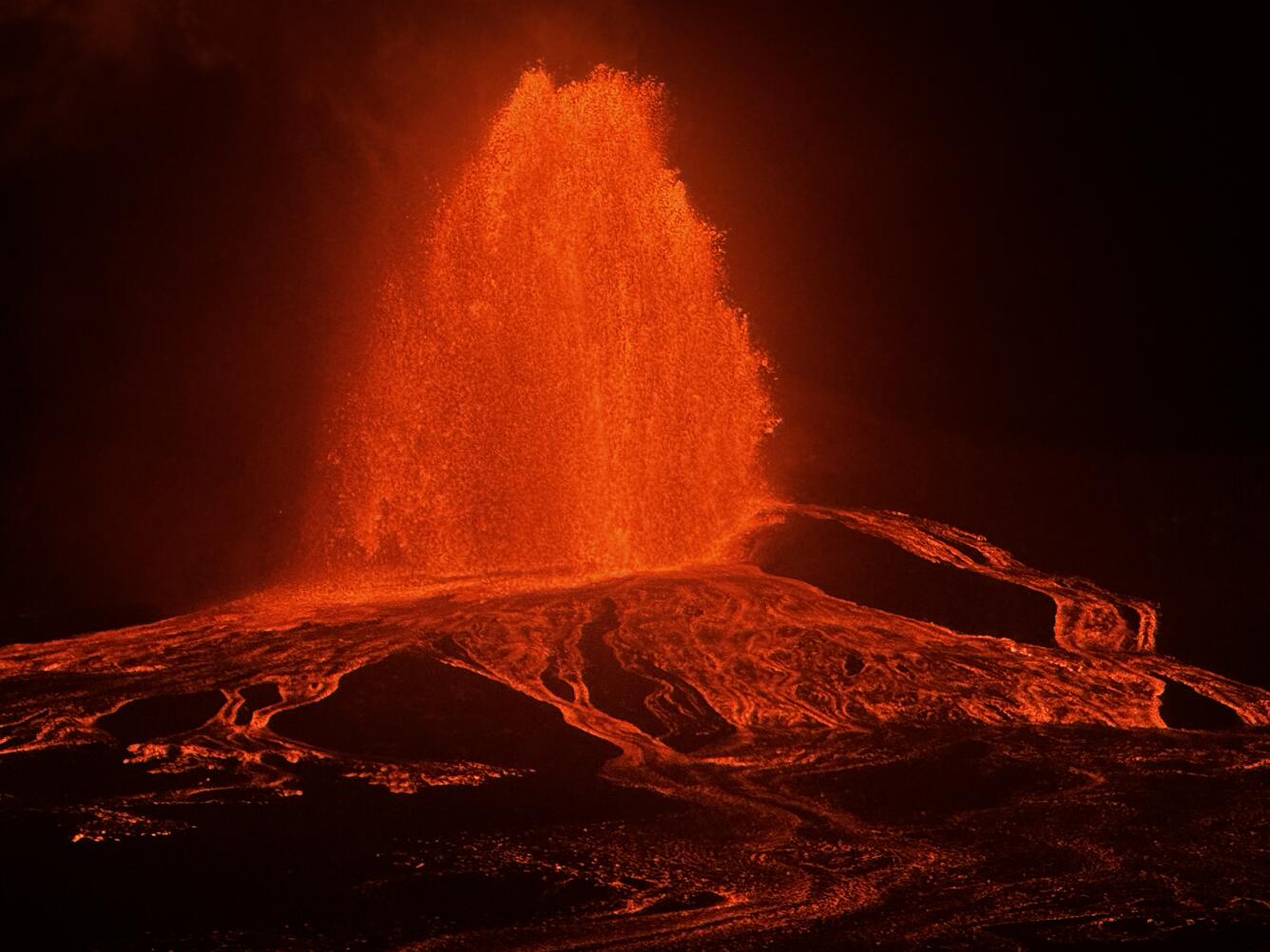 Color photograph of lava fountain at night