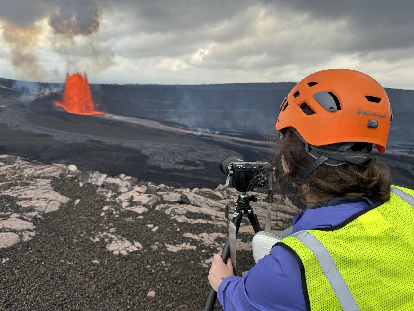 Color photograph of scientist monitoring volcanic eruption