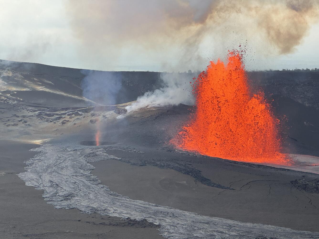 Color photograph of lava fountain and volcanic gas jet