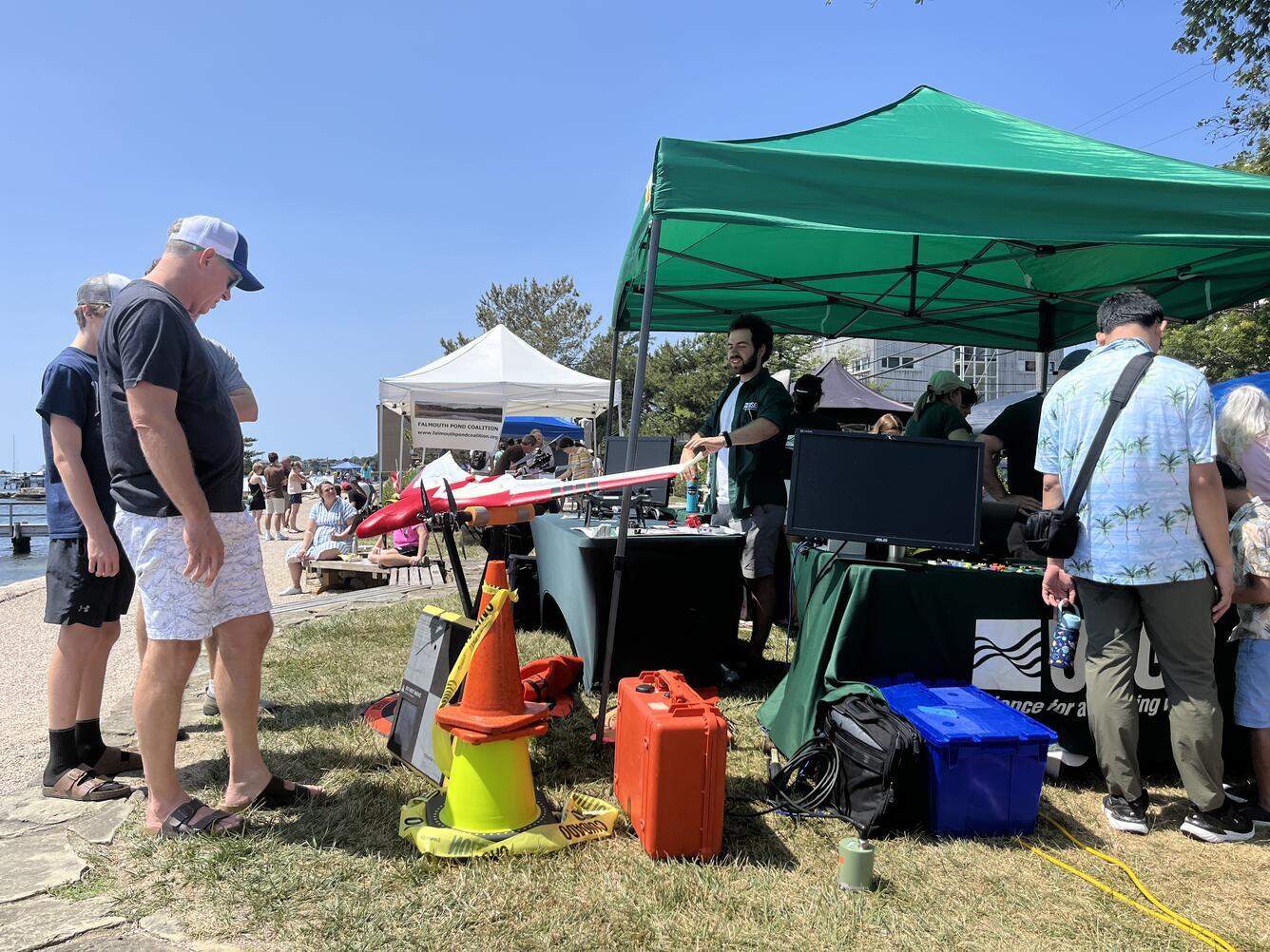people looking at drone at USGS tent outside