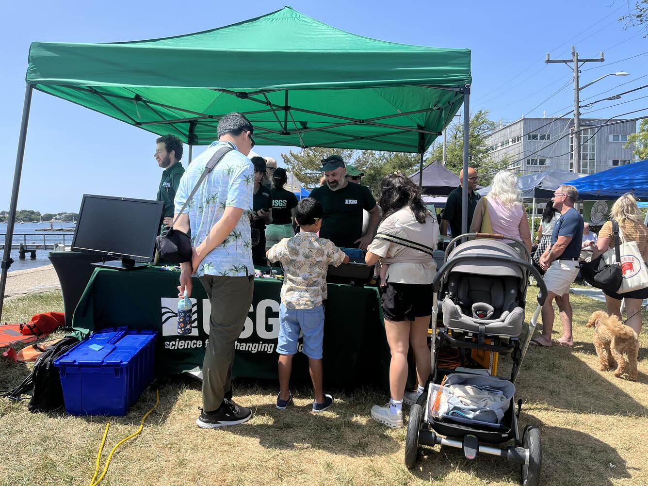 a family visiting a USGS booth outside