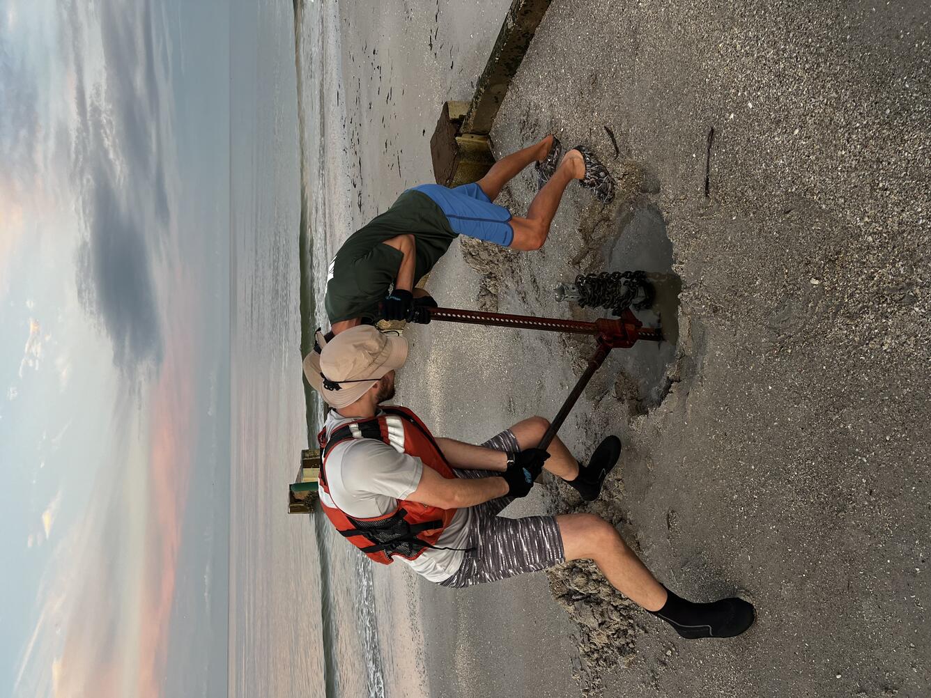 USGS researchers retrieving post