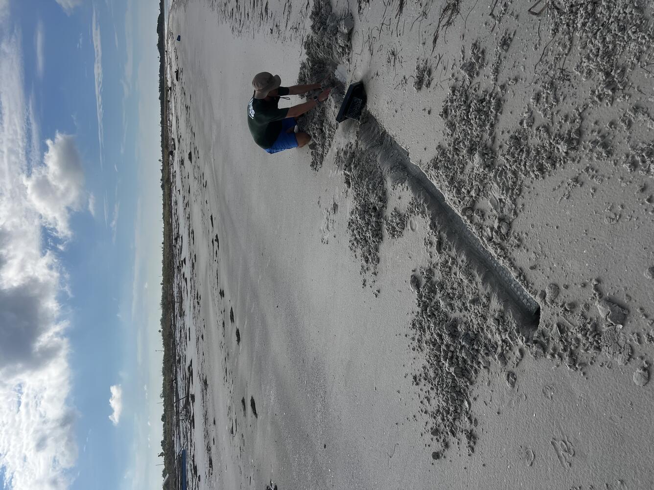 Equipment being excavated from sand