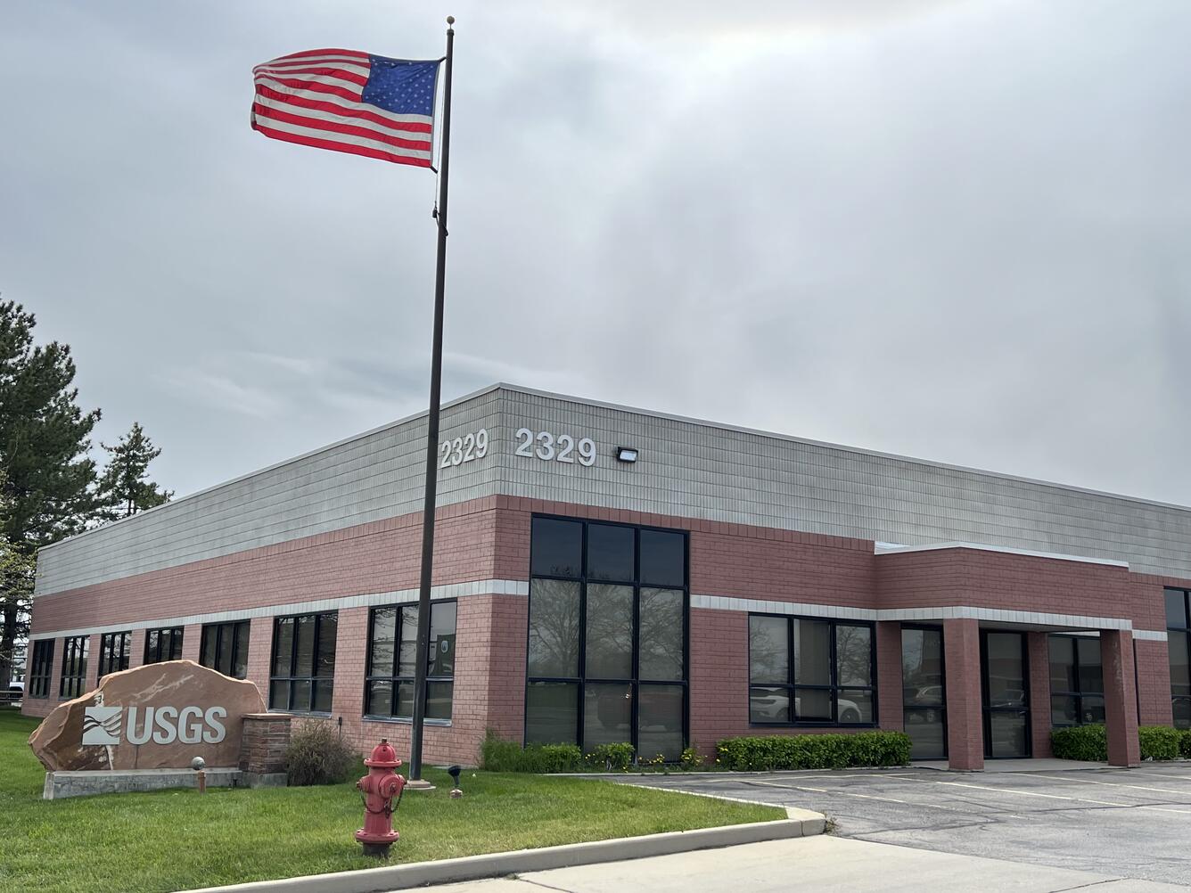 Utah Water Science Center, Salt Lake City building with sign, flagpole, and fire hydrant at corner.
