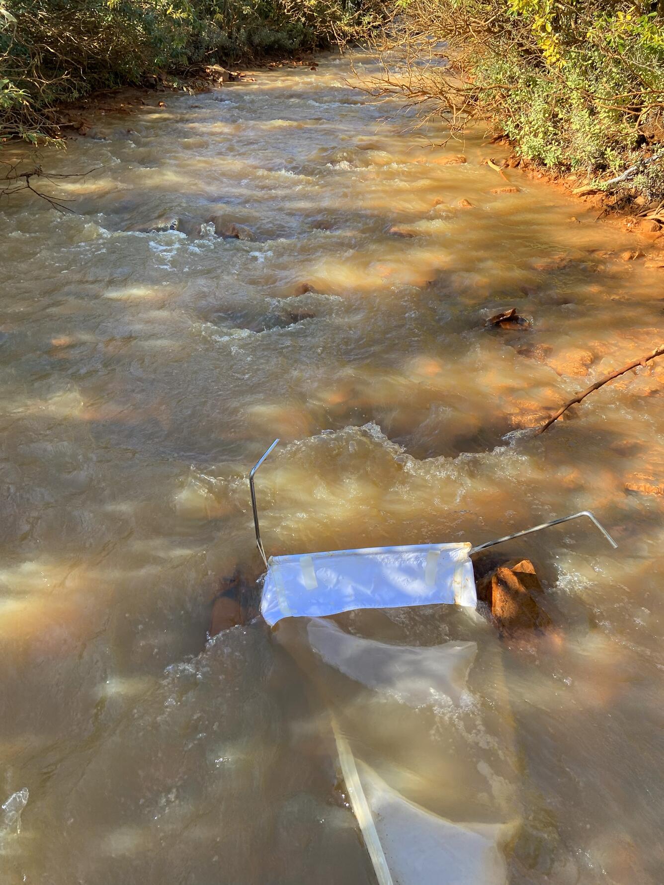 A white net in an orange creek.