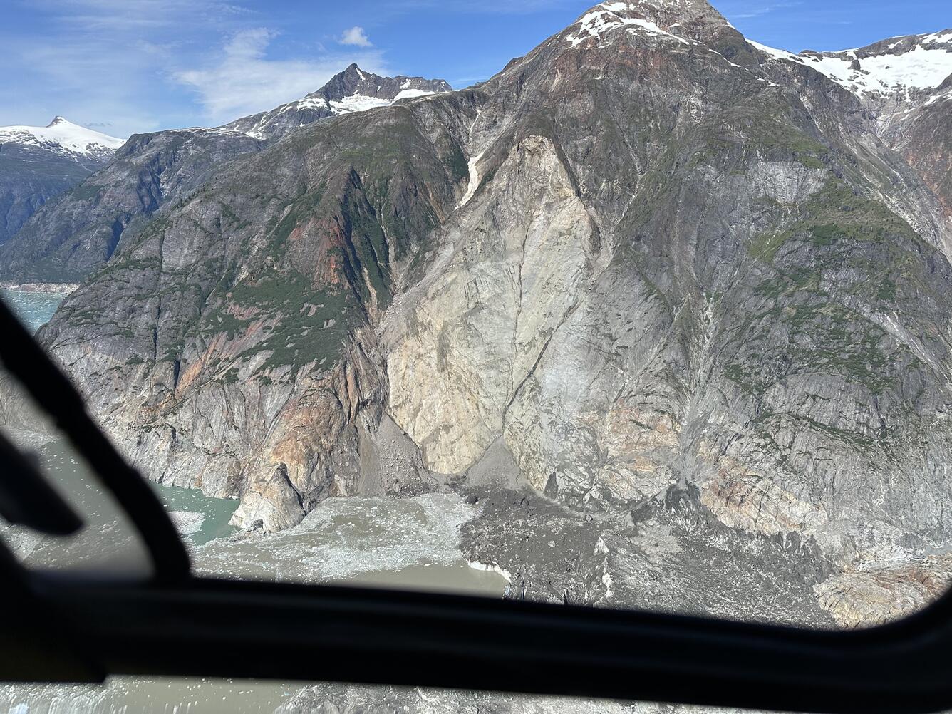 Aerial photo of steep mountainside showing the landslide source area.