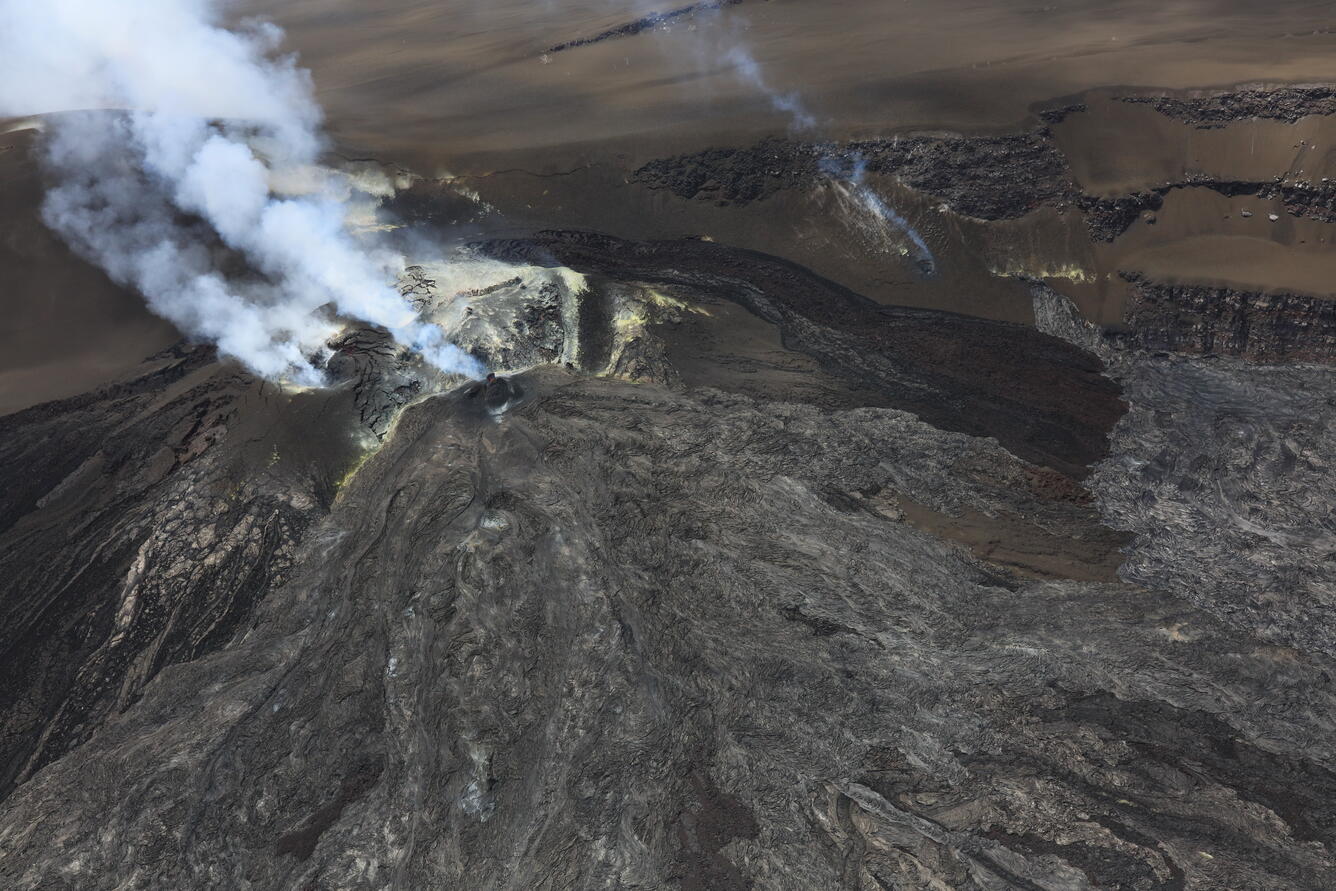 Color photograph of volcanic vents degassing