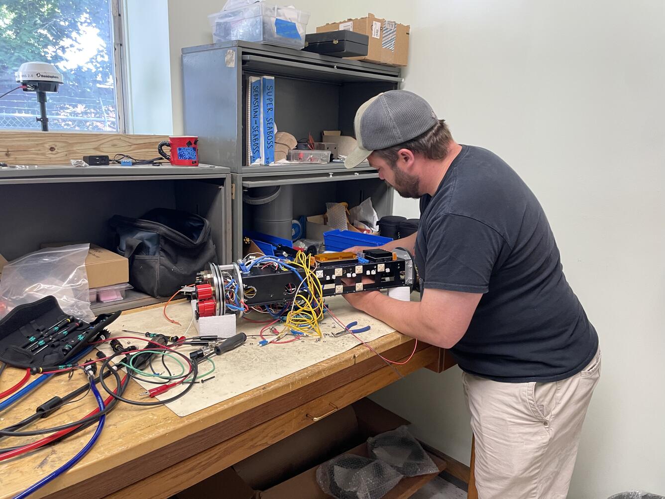 Person working on small piece of equipment