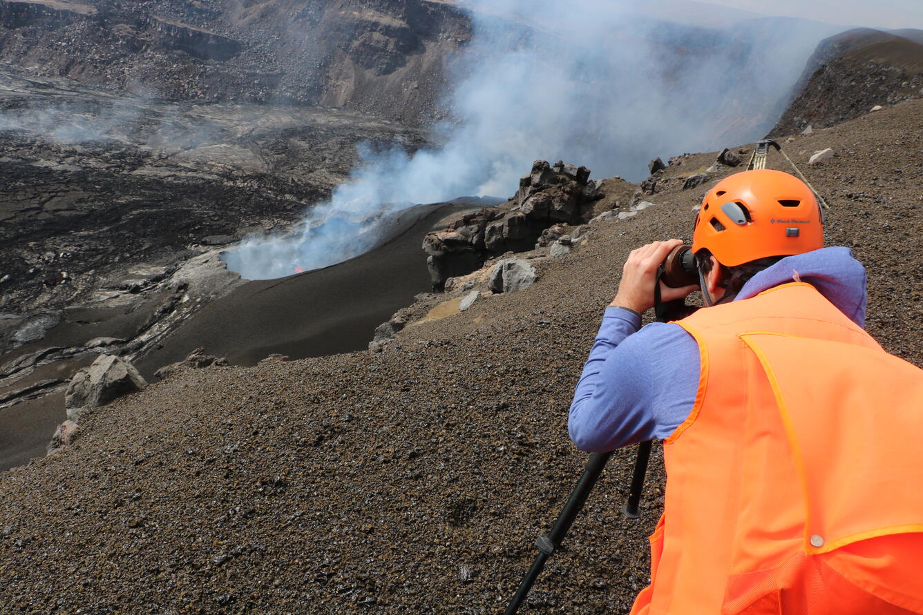 Color photograph of scientist monitoring eruption