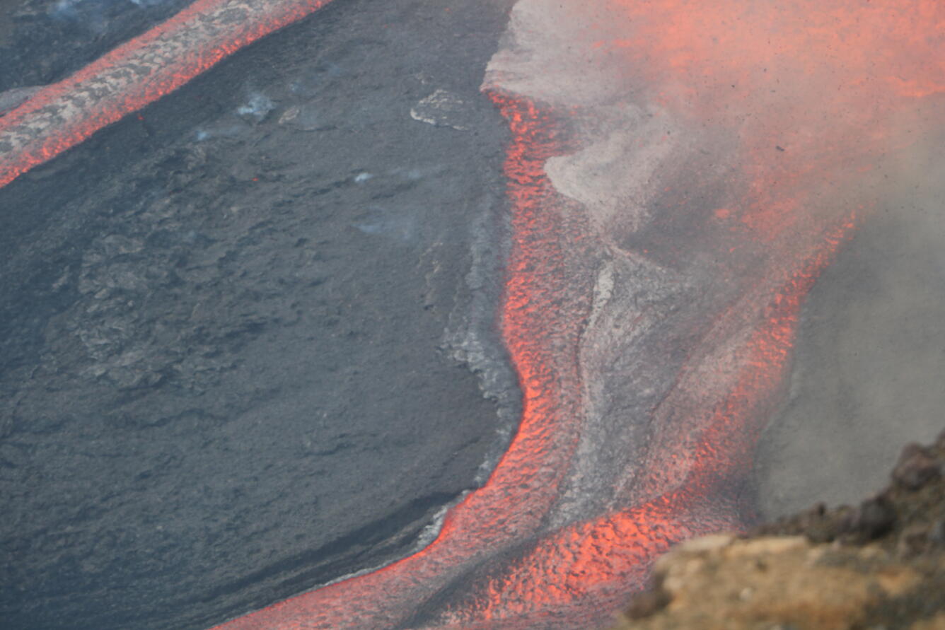 Color photograph of lava channel flowing during eruption