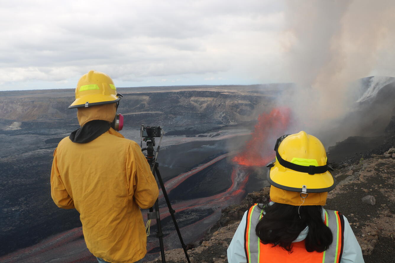 Color photograph of scientists monitoring eruption