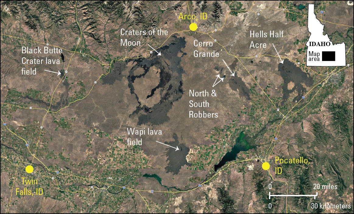 satellite image with agricultural areas and highways and isolated patches of lava flows from recent eruptions in Idaho