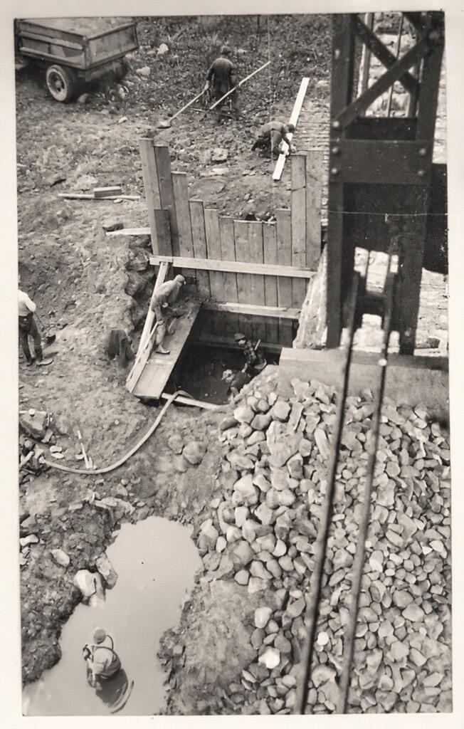 Wooden framework forming the hole into the ground at the foot of the old bridge