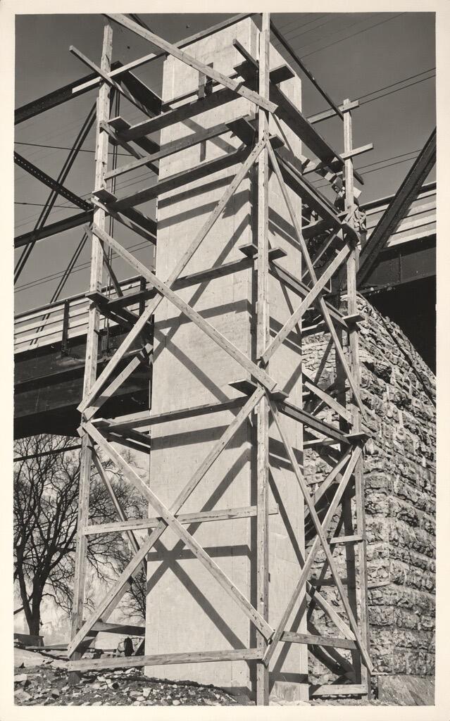 concrete structure is framed out at its full height next to a bridge