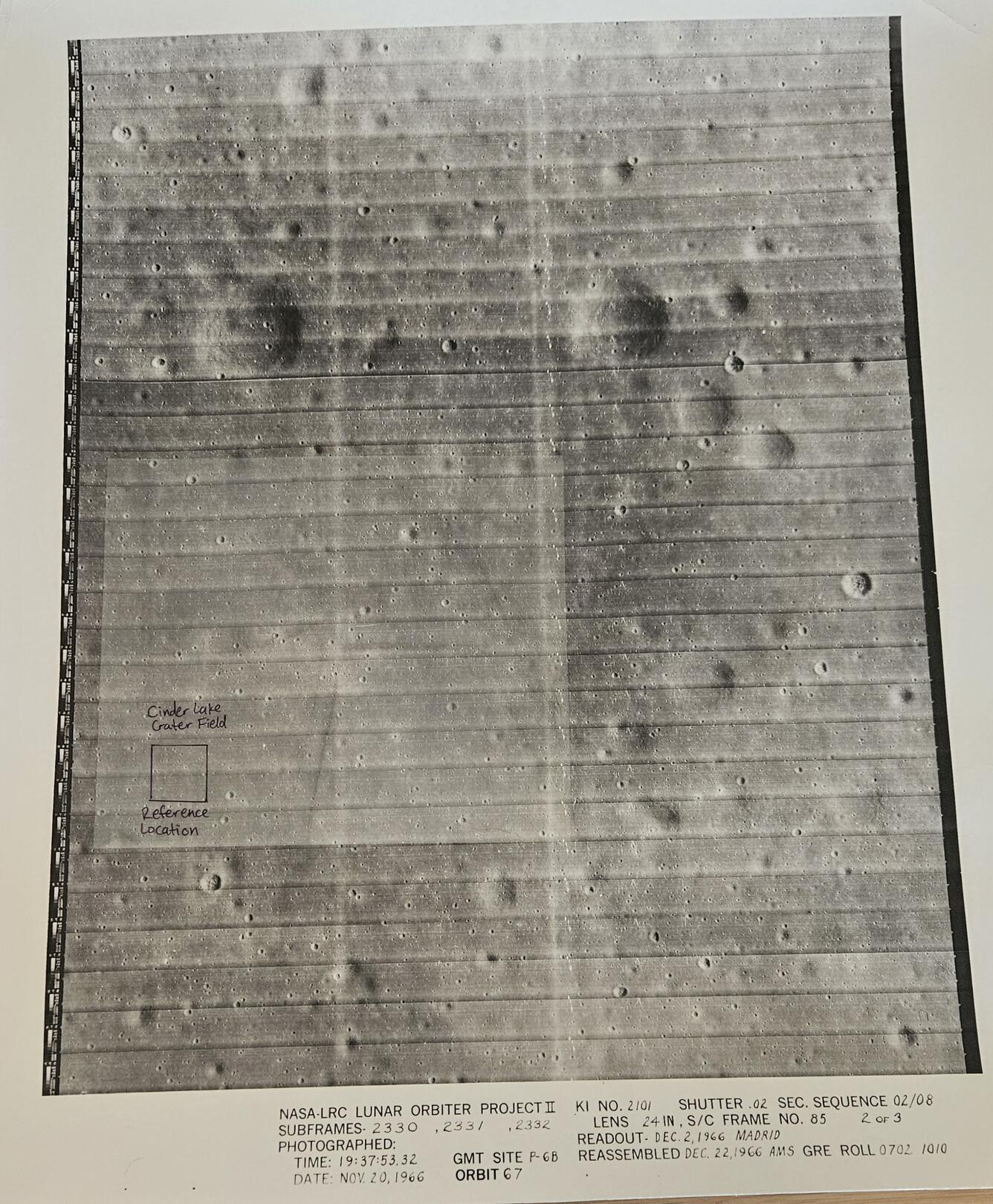 Photo of a printed image of the lunar surface with a small box over a region labeled "Cinder Lake Crater Field Reference"