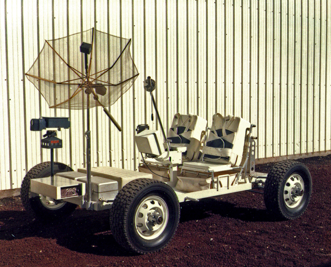 A photo of Grover the Geologic Rover against an aluminum corrugated wall