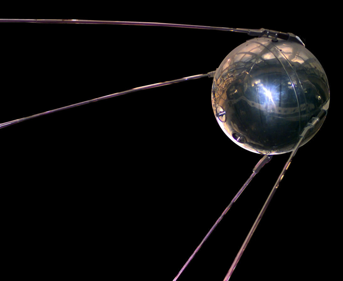 The Sputnik spacecraft: a shiny, silver ball with four thin rods extending away from the ball in a swept-back pattern