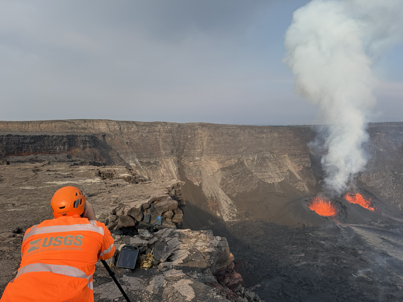 Color photograph of scientist monitoring eruption
