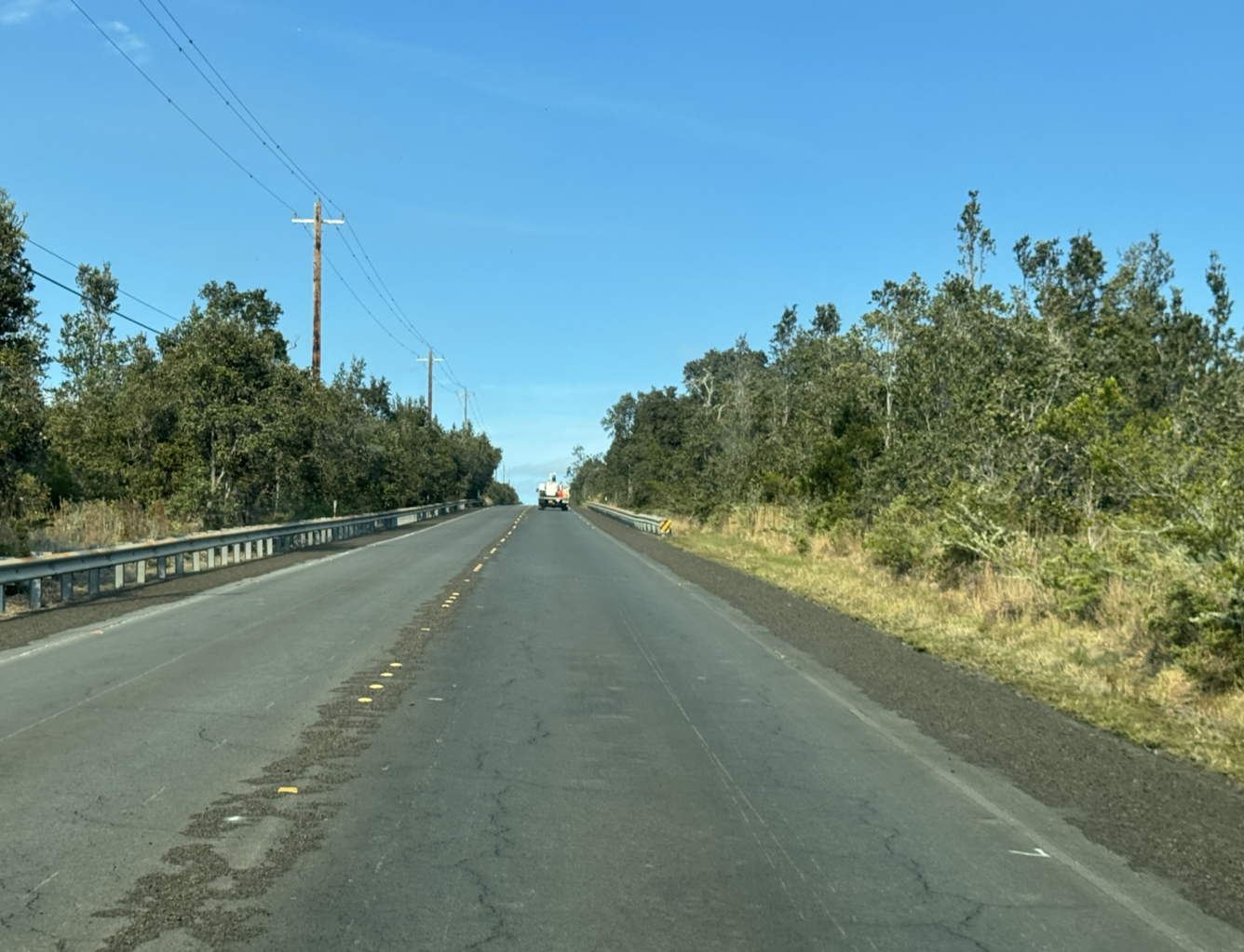 Color photograph of road with tephra on the side