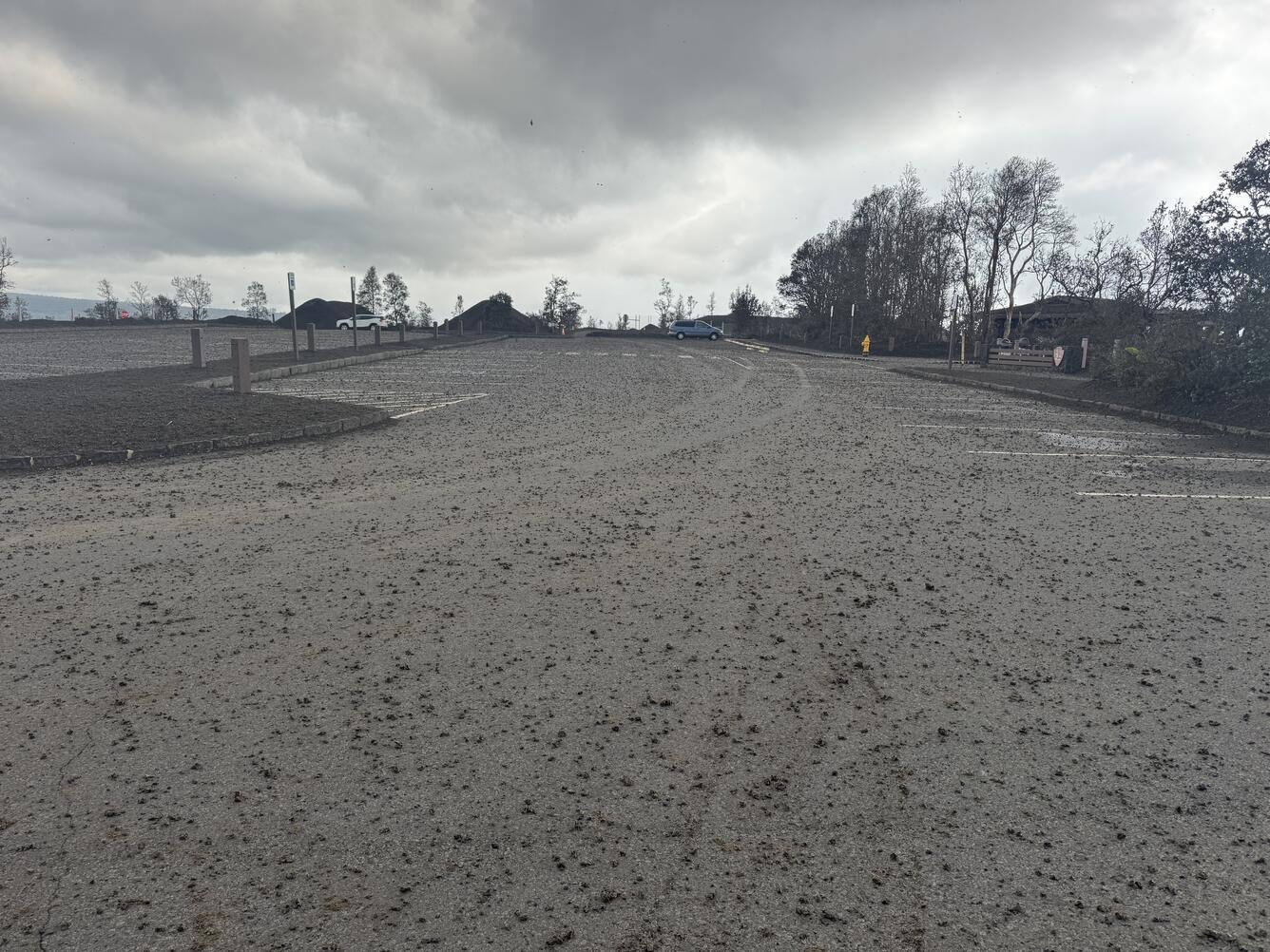 Color photograph of sparse volcanic fallout in parking log