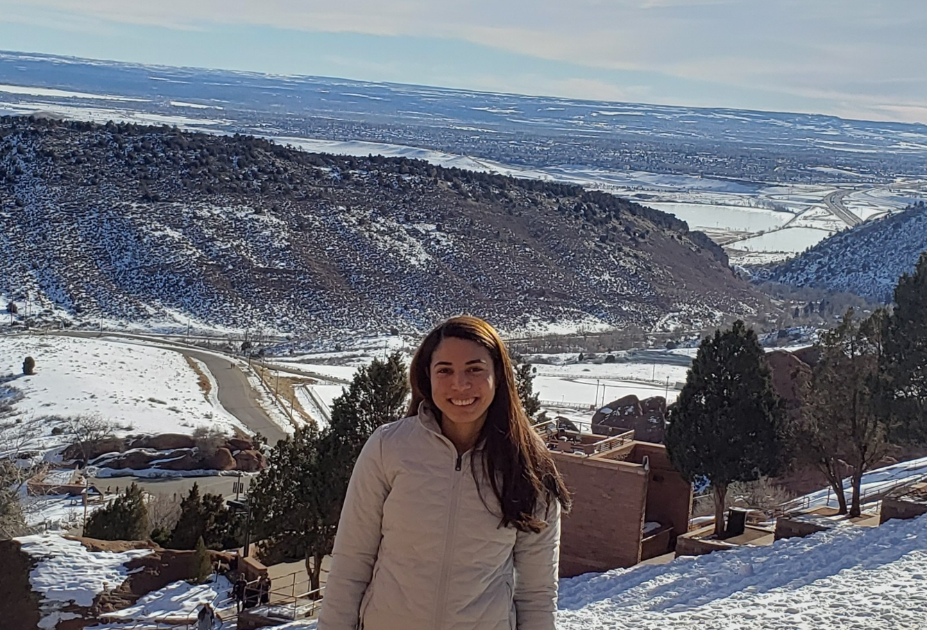 TNMCorps volunteer jessicasouza in front of a snowy landscape. 