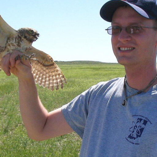 Justin Welty holding an owl