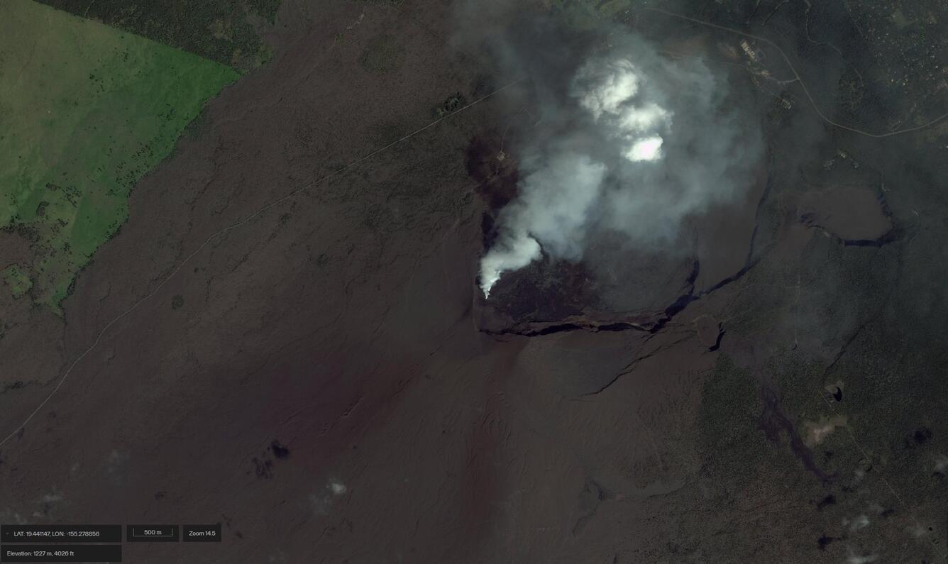Satellite image of the summit of a volcano showing a caldera and volcanic gas plume