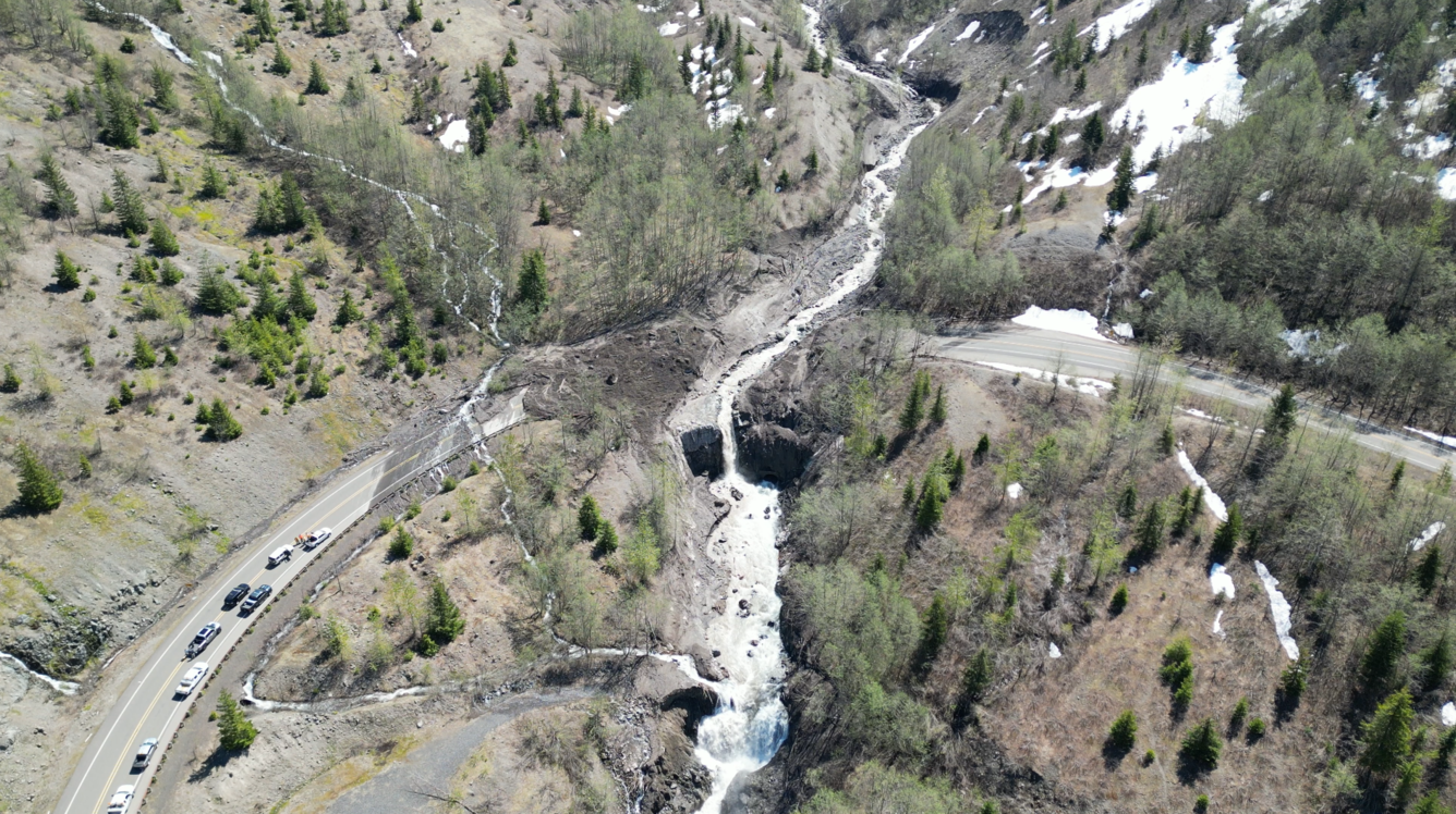 Aerial view of highway blocked by mud, water, and debris