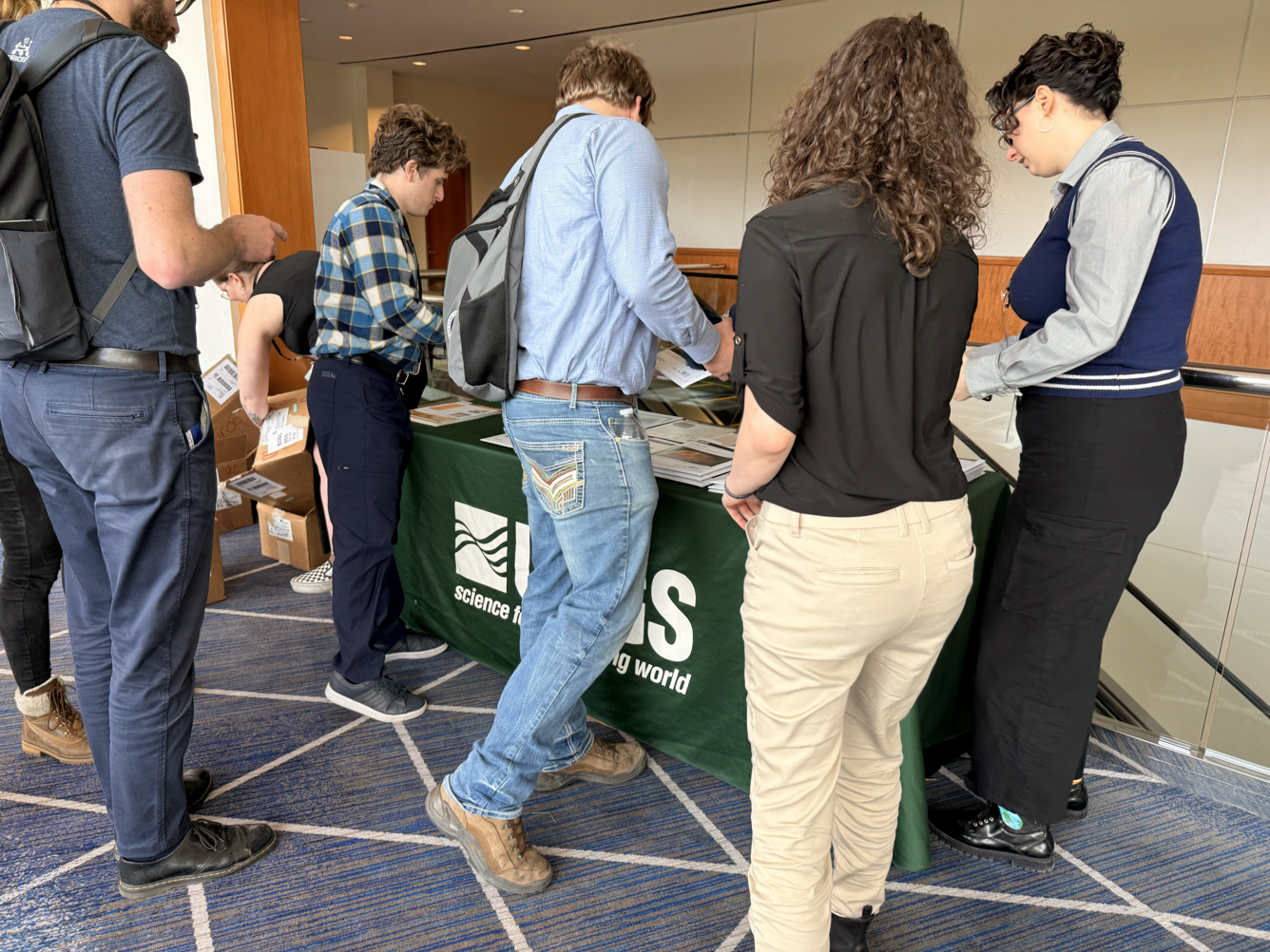 Sonya Bogle, in the middle-left corner, diligently searching for additional maps amid empty boxes, found herself nearly overwhelmed by the high demand for USGS maps.
