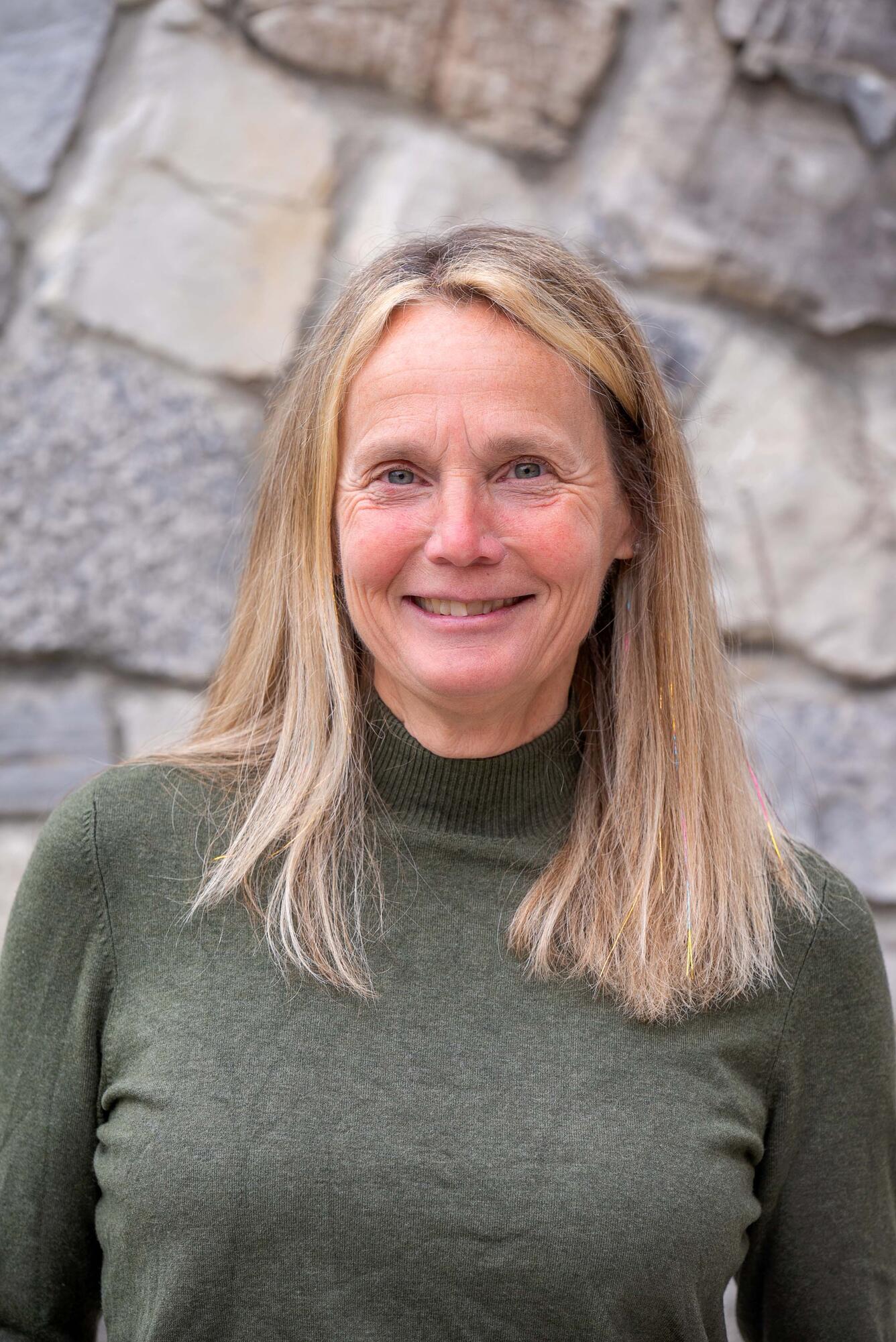 Headshot of Karen Knot's in green sweater