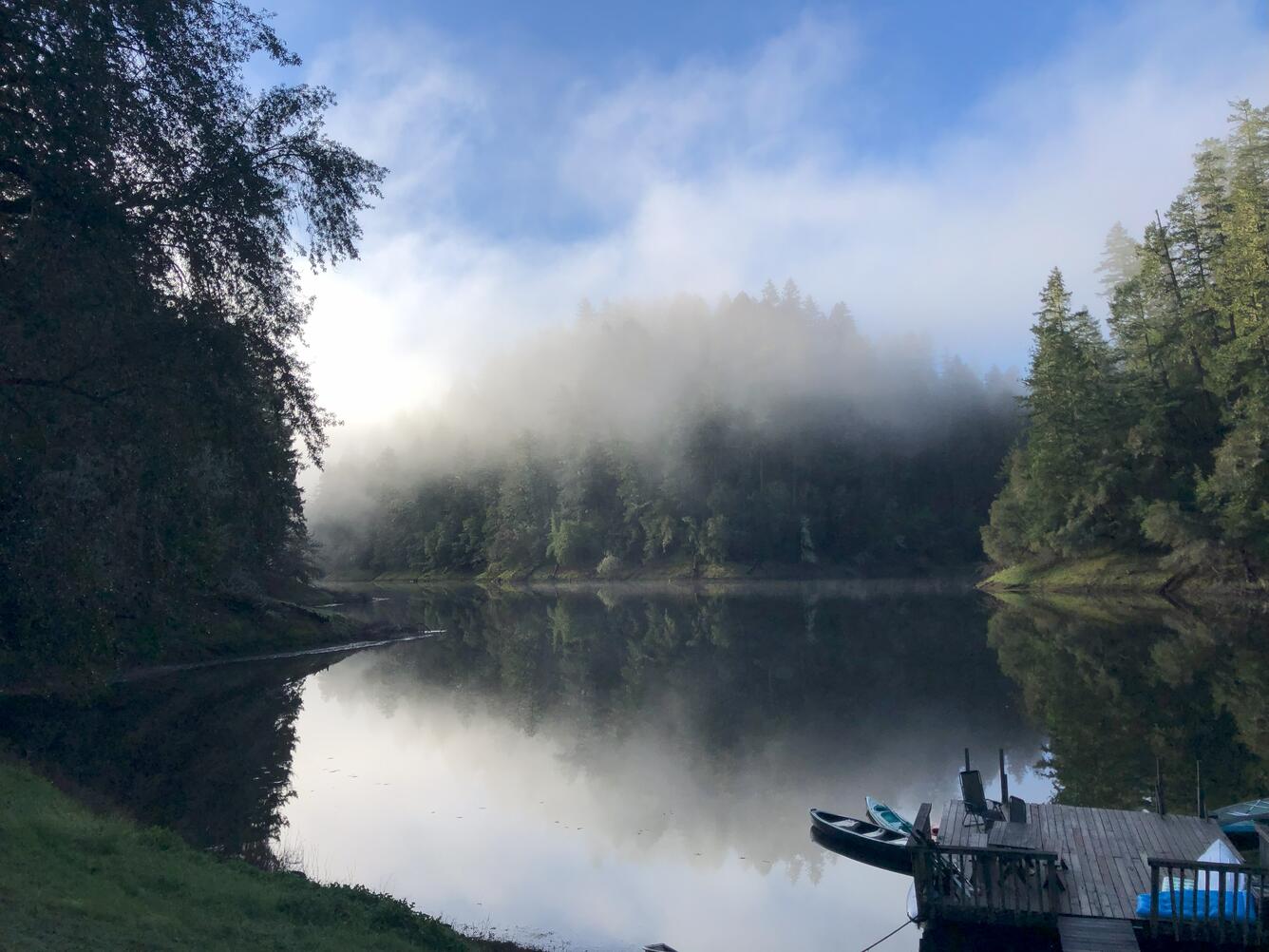 morning fog over calm lake waters