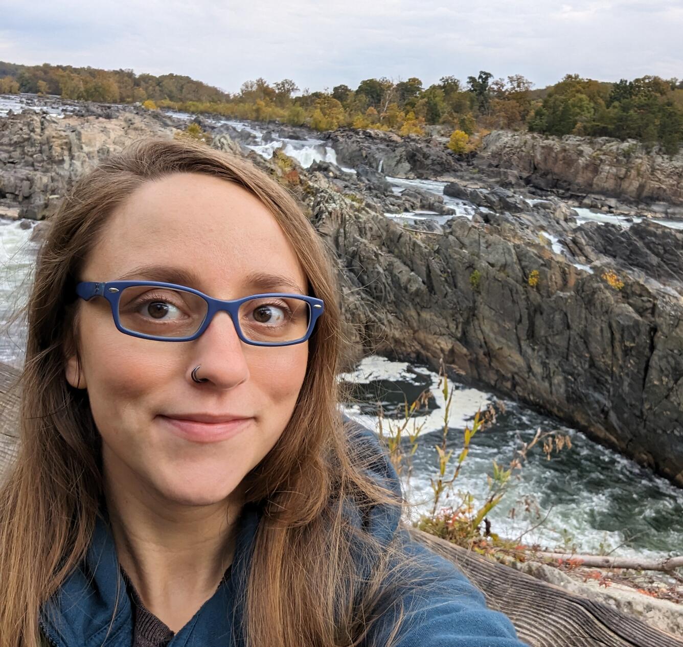 Lisa smiling standing in front of the Potomac River 