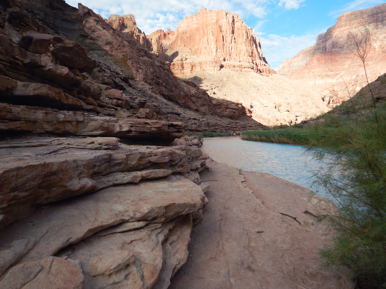 The light blue Little Colorado River winds through a rocky canyon in Grand Canyon
