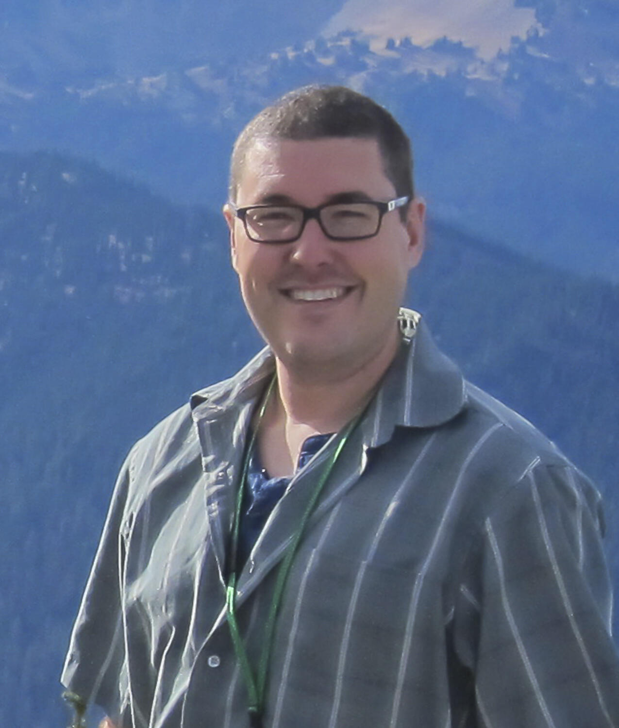 Chis Lockett outside in front of mountains.