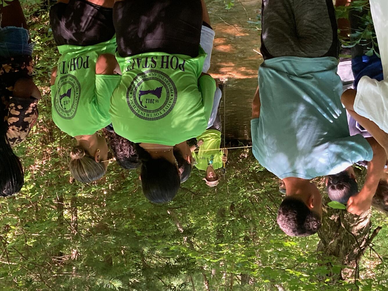 group of people in wooded area