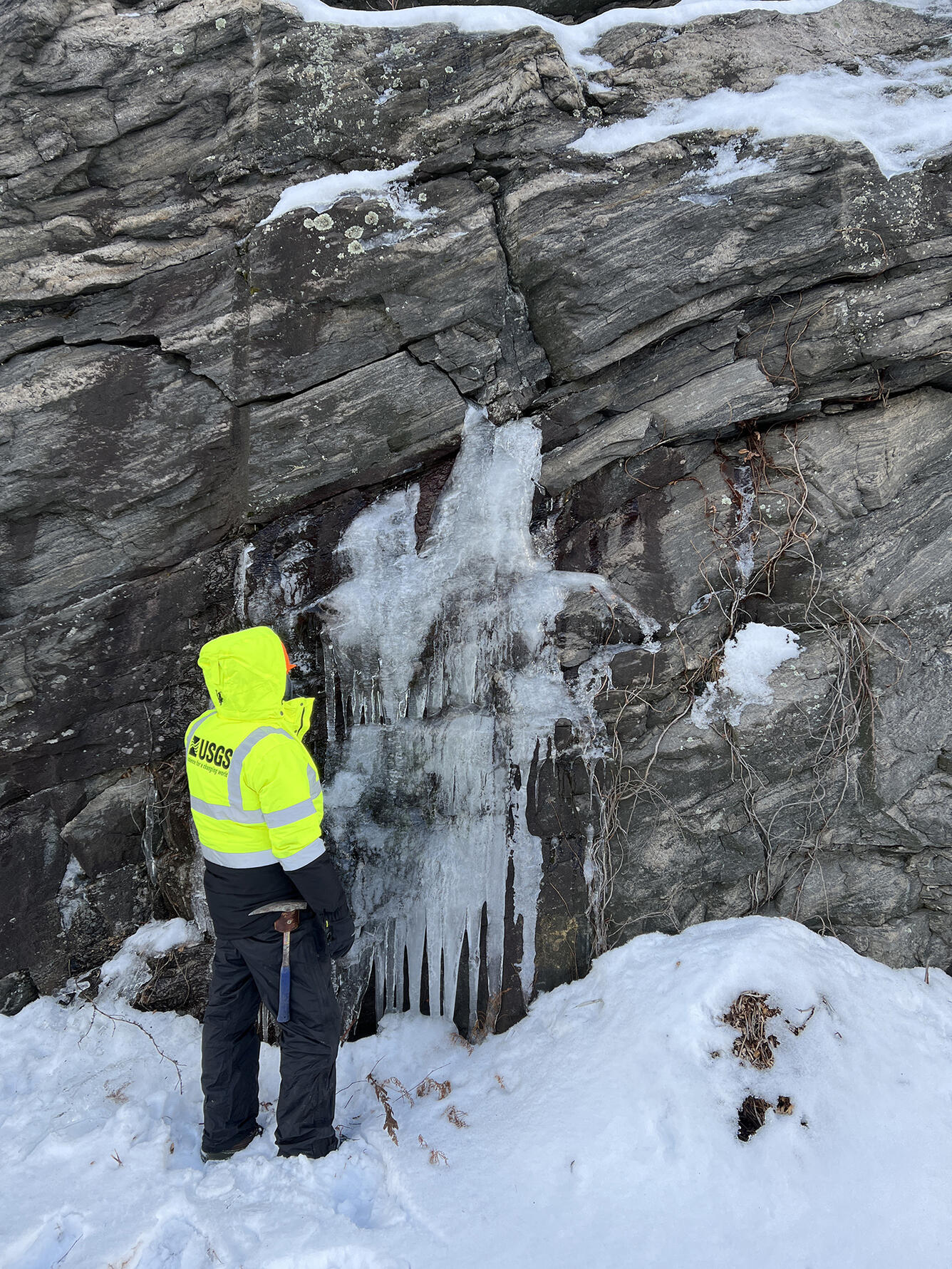 Geologist examines water bearing fractures.
