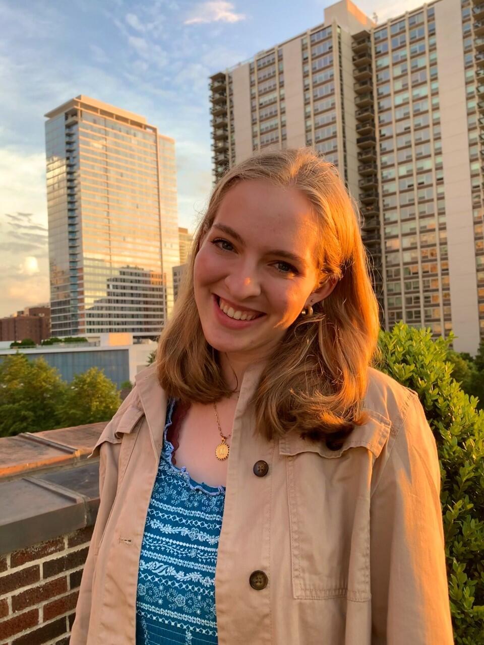 Smiling woman with high rise buildings in background