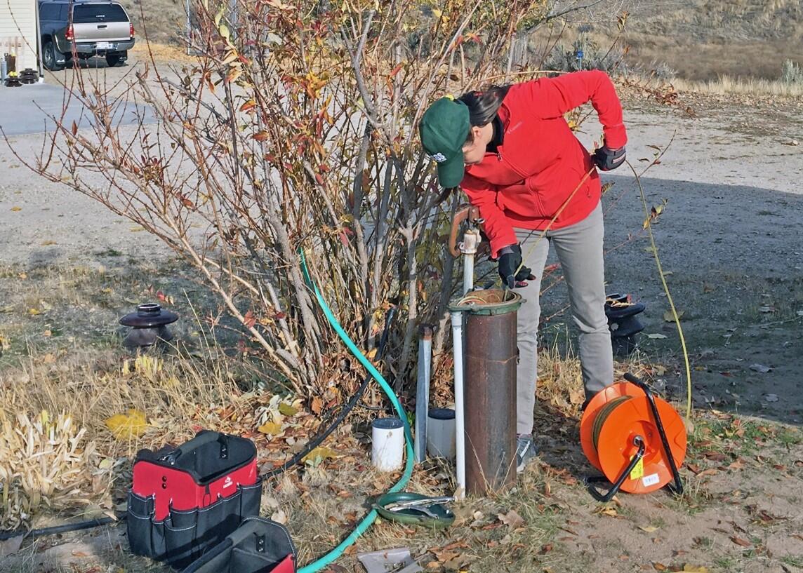 USGS hydrologist measures the water level in a well