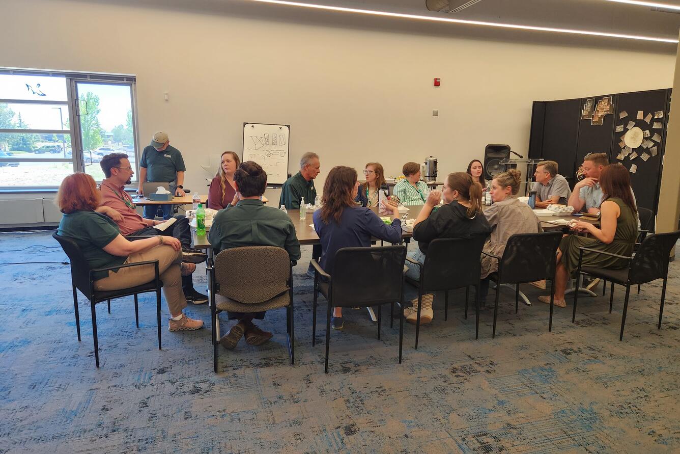 Photo of a lunchtime meeting where discussions are directed to Leadership.
