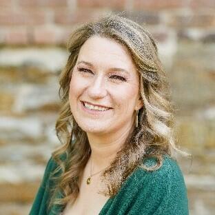 Headshot of Megan Elliott, wearing a green blouse.