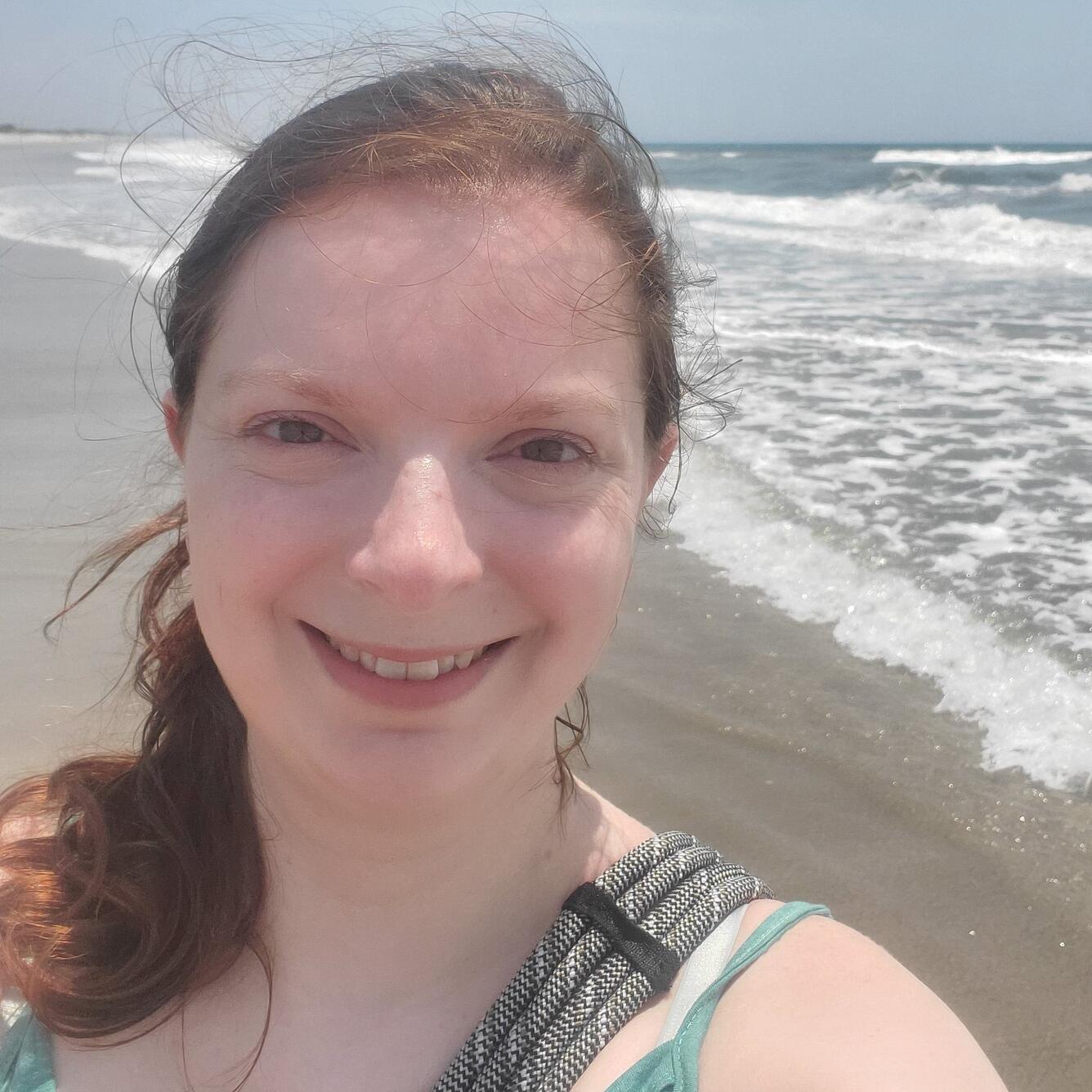 photo of a woman with beach in the background